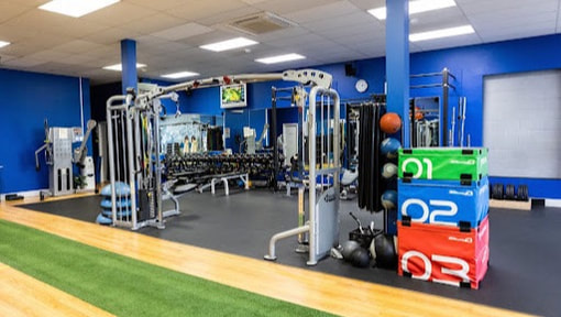 Dumbbell racks, benches and cable machines on the studio floor